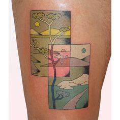 a cross tattoo on the side of a man's leg with mountains in the background