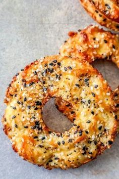 three fried onion rings with sesame seeds on them