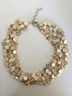 This cream pearl necklace is another classic piece to add to your collection! The stacked design can look chunky but the use of pearls gives the entire piece an elegant style. It gives you a gorgeous layered looked without effort! Wear it with formal clothing or style it with casual outfits. Closure: Spring Ring You can find other color in variation. If you like this piece, see more like it at my store: https://www.etsy.com/shop/GarrisonJewelry Pearl White Multi-strand Pearl Necklace, Cream Pearl Pendant Necklace, Cream Multi-strand Pearl Necklaces, Cream Pearl Multi-strand Necklace, Cream Multi-strand Pearl Necklace, Elegant Multi-strand Beige Necklace, Elegant Silver Round Beads Shell Necklace, Beige Pearl Necklace Gift, Elegant Silver Shell Necklace With Round Beads