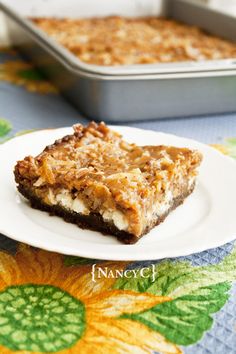 a piece of dessert sitting on top of a white plate next to a baking pan