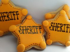 three decorated cookies with the words sheriff on them