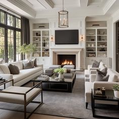 a living room filled with furniture and a flat screen tv mounted on the wall above a fireplace