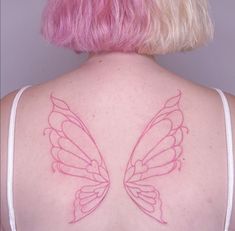 the back of a woman's shoulder with pink hair and butterfly wings on it