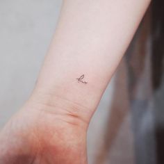 a small bird tattoo on the wrist