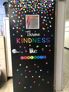 a black refrigerator covered in colorful confetti and writing that says throw kindness like goodbye