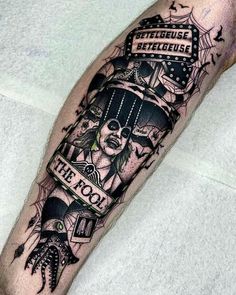 a man's leg with a tattoo on it that reads the fool and features an image of a skeleton