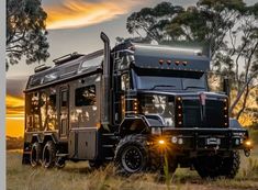 a large truck parked on top of a grass covered field