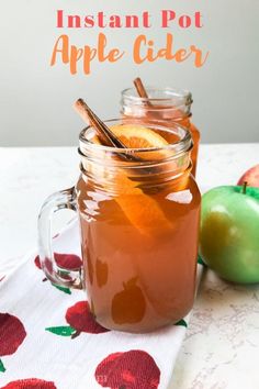 an apple cider in a mason jar with cinnamon stick sticking out of the top