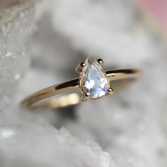 Moonstone is known as a stone of protection and is associated with the crown and third eye chakras.  Bring the moonstone's protective energy into your life with our 14K "Chakra" ring!  Handcrafted from 14K gold and featuring a pear-shaped rainbow blue moonstone in a bezel setting.  - Rainbow blue moonstone measures 6mm by 4mm, very high VS quality, picks up colors of pink, yellow, blue, and purple   - Choose between soldi 10K or 14K gold - Round band measures 1.3mm in width Processing Times -  C 14k Gold Spiritual Moonstone Ring, Gold Moonstone Ring For Healing, Gold Moonstone Healing Ring, 14k Gold Moonstone Ring For Anniversary, Spiritual 14k Gold Moonstone Ring For Anniversary, Spiritual Teardrop Moonstone Ring, White Celestial Moonstone Ring In 14k Gold, Spiritual Moonstone Teardrop Ring, Ethereal White Moonstone Promise Ring