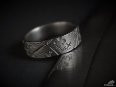 a silver ring sitting on top of a table