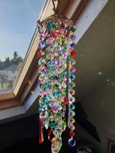 a multicolored chandelier hanging from a window