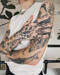 a woman with tattoos on her arms and hands