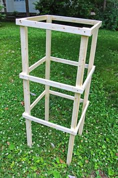 a wooden shelf sitting on top of a lush green field