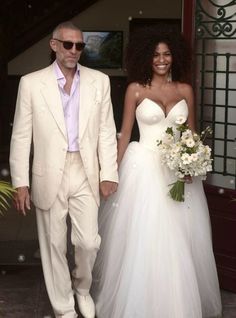 the bride and groom are walking down the steps