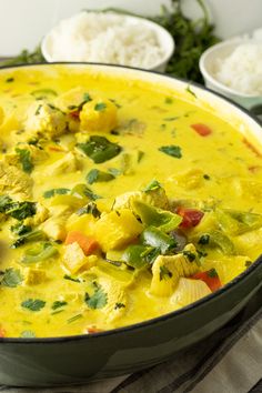 a bowl filled with yellow curry and vegetables