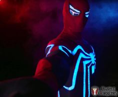 a man in a spider - man suit with blue and red lights on his face