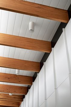 an instagramted photo of the ceiling in a room with white walls and wood slats