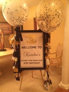 a welcome sign with balloons and streamers