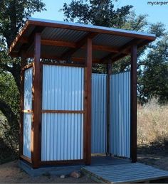 a small metal structure in the middle of a field