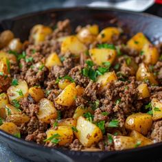 a skillet filled with ground beef and potatoes