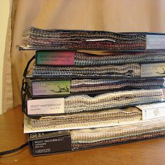 a stack of books sitting on top of a wooden table