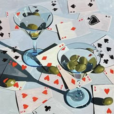 two martinis with olives and playing cards