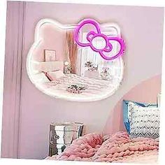 a hello kitty mirror on the wall above a bed