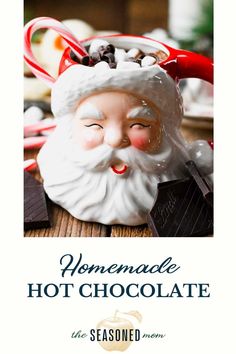 a close up of a santa clause head on a table with chocolates in it