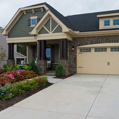 a house with flowers in the front yard