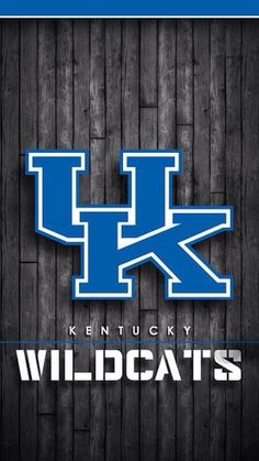 the kentucky wildcats logo on a wooden background