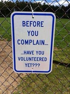 a blue and white sign that says before you complain have you volunteered yet?