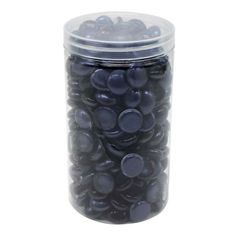 a glass jar filled with lots of black candies