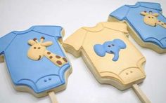 three cookies shaped like baby ones with giraffes on them