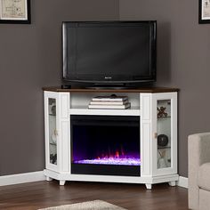 an entertainment center with a television and fire place in front of a flat screen tv