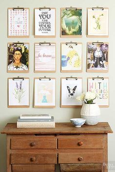 a wooden dresser sitting next to a wall filled with pictures and papers on it's side