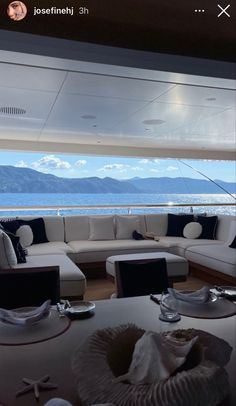 the interior of a boat with mountains in the background