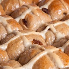 a close up view of hot cross buns with icing