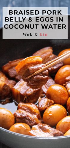 cooked pork belly and eggs in coconut water with chopsticks cooking in a wok