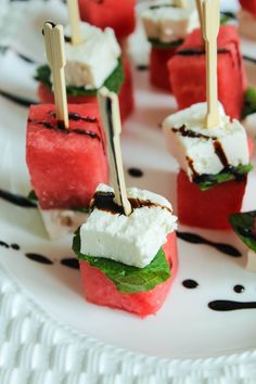 watermelon skewers with marshmallows and mint on a white plate