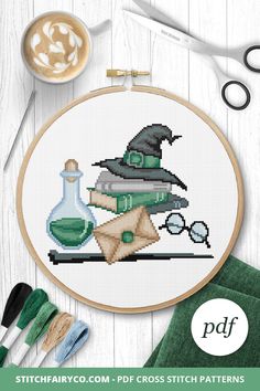 a cross stitch pattern with an image of a wizard's hat and flask