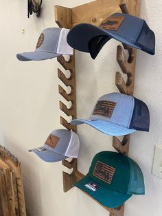 several hats are hanging on a wooden rack