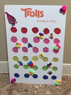 a bulletin board with lots of holes and pom - poms on it's sides