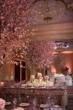 the tables are set with flowers, candles and place settings for an elegant wedding reception