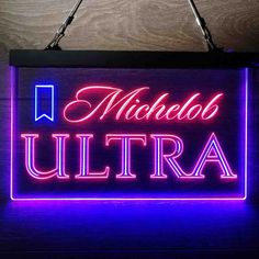 a neon sign that reads michelo ultra on it's side hanging from the ceiling