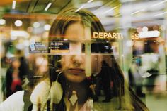 the reflection of a woman's face in a window