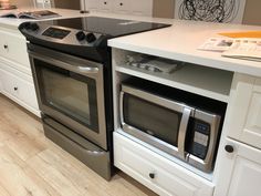 a kitchen with two ovens and an island in front of the stove top is shown