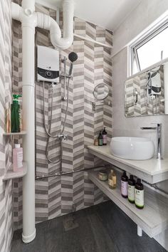 a bathroom with grey and white striped walls