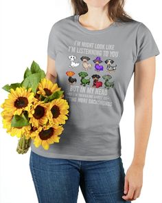 a woman is holding a sunflower and wearing a t - shirt