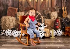 a little boy sitting in a rocking chair next to stuffed animals and hay bales