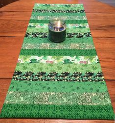 a green table runner with a candle on it